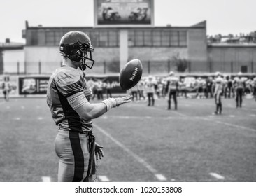 The Player Of The American Football Team Is Throwing The Ball With His Hand.