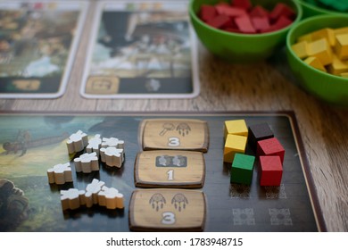 Player board with wooden game pieces from Century: A New World board game. 26th July, Vienna 2020.