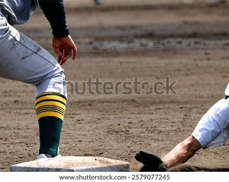 A player doing a head slide to return to first base in a baseball game