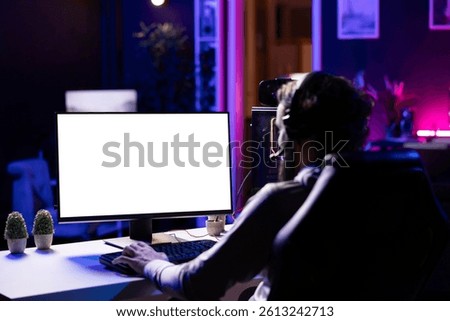 Player having fun by using isolated screen computer display to play singleplayer videogame. Professional gamer using mockup PC desktop to complete levels in game, talking with friends