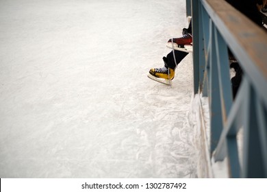 Player laces up his colorful ice skates getting ready to go to the rink - Powered by Shutterstock