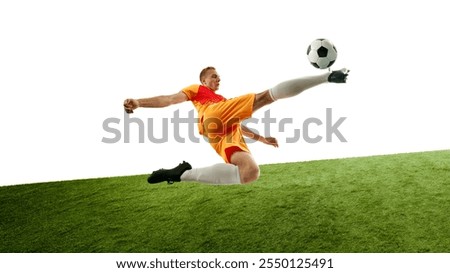 Player performs powerful kick while in air, maintaining balance and focus, with ball closely following his motion against white background with green field. Concept of competition, sport games. Ad