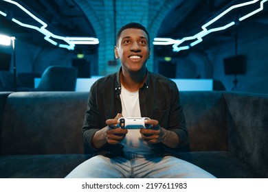 The player plays the console. Neon gaming room. High quality photo - Powered by Shutterstock