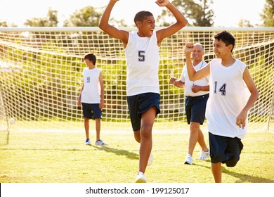 Player Scoring Goal In High School Soccer Match - Powered by Shutterstock