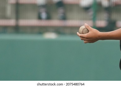 A Player Tries To Hand The Ball To The Knocker During A Sheet Knock In Baseball.