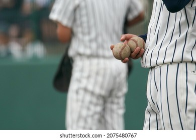 A Player Tries To Hand The Ball To The Knocker During A Sheet Knock In Baseball.