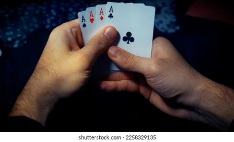 The player watches art while playing poker. A combination of four aces, four of a kind, winning cards fell out - Shutterstock ID 2258329135