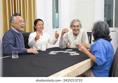 playful asian senior friends meet and play cards game together,they are talk and smile,elderly retired people entertainment,recreation,encourages social interaction,help memory retention   - Powered by Shutterstock