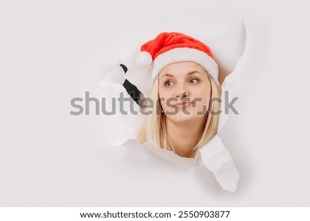 Similar – Image, Stock Photo Woman peeking through Christmas wrapping paper, festive mood
