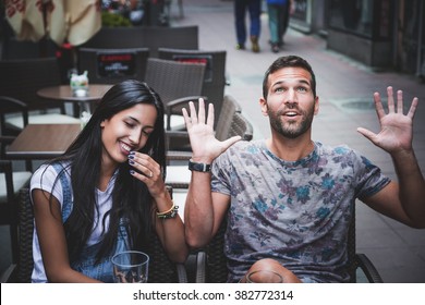 Playful couple laughing in a bar