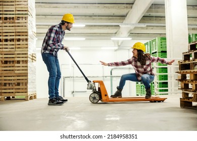 Playful Factory Workers Having Fun And Playing Game With Forklift At Work.