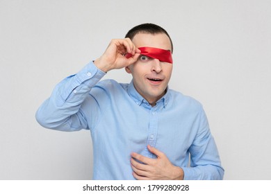 Playful Funny Man Removes Blindfold, Portrait, White Background, Copy Space