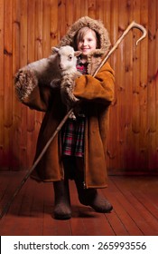 Playful Girl Shepherd With His Staff Under His Arm A Lamb On The Farm