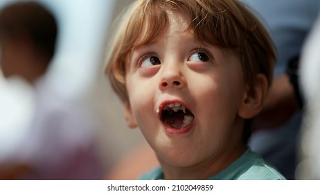 Playful little boy opening mouth with food inside. mischievous child misbehaving
