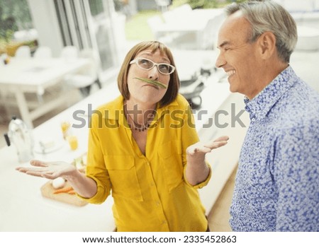 Playful mature woman with green bean mustache