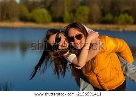 Similar – Happy women embracing and laughing over nature background