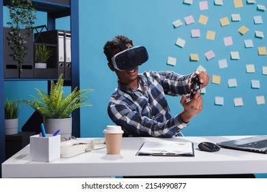 Playful Office Person Wearing Virtual Reality Technology Headset While Using Modern Controller To Casually Play Video Games At Work. Finance Department Team Leader Enjoying Playing On Console.