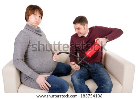 A playful picture of a young couple awaiting baby.isolated
