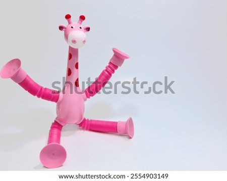 A playful pink giraffe toy with flexible, detachable limbs, showcasing a fun design against a clean white backdrop.