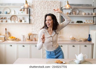 Playful Woman Singing At Appliance As Imaginary Microphone, Dancing In Kitchen Interior Alone, Free Space. Fun At Home Alone, Lady Superstar Enjoy Free Time