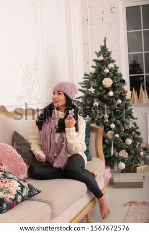 playful young woman celebrates christmas