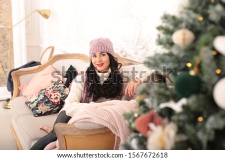 playful young woman celebrates christmas