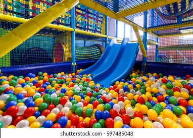 Playground with ball pit indoor, plastic dry pool and slide for playing and sport. Inside kids playground, nice colorful gym. Children's playground like jungle and maze. Playroom, recreation theme. - Shutterstock ID 597485048