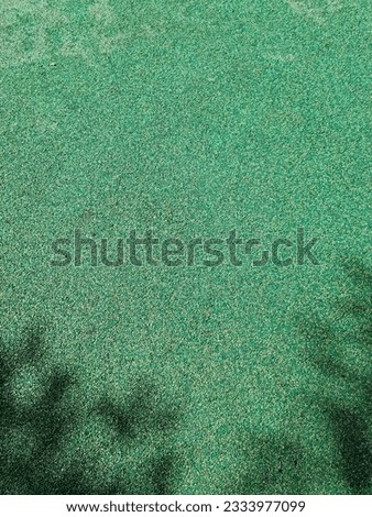 It is a playground floor covered with green urethane.