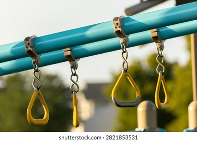 Playground monkey bars worn down from use 
