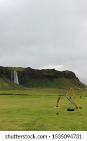 Playground With Slide And Swingset Lonely  In Nature With Waterfall