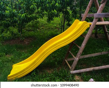 Playground slide yellow color in the garden