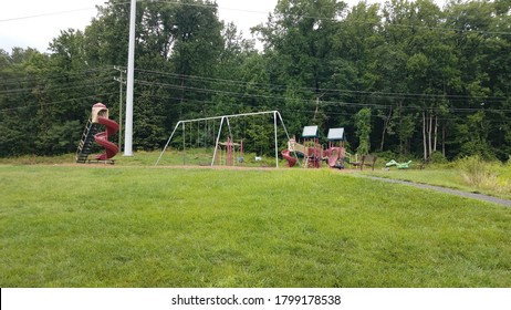 playground with slides and swingset and grass