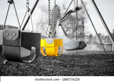 Playground Swing Set For Toddlers With Full Bucket Seats, Close Up. Black And White Image With One Seat In Bright Yellow Accent Color. Selective Color. Concept For Detect Early Signs Of Development.