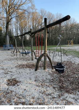 Playground swing with wooden frame