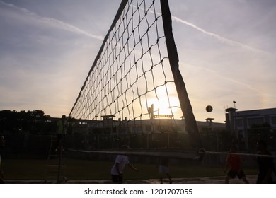 Playing Beach Volleyball In Late Afternoon