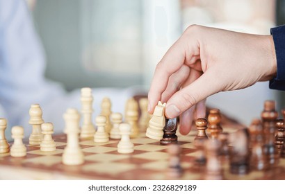 Playing, board game and chess checkmate with a man at a table while moving piece for strategy or challenge. Hands of a male person to play, relax and bond while moving icon for problem solving or win - Powered by Shutterstock