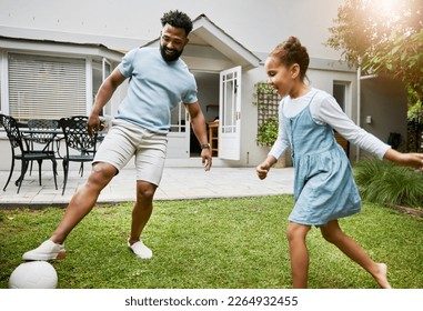 Playing, bonding and having fun in a garden with a smiling father and happy little girl outside. Dad teaching football, learning and showing his daughter how to kick a soccer ball outdoors together - Powered by Shutterstock