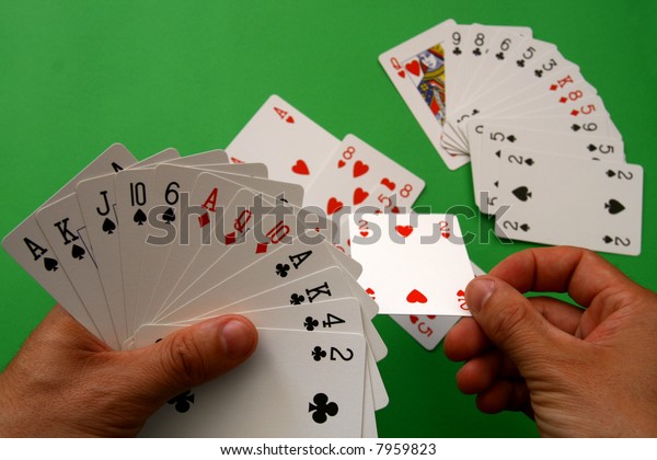 playing\
bridge - one hand (A,K,J,10,6 spades, 2 heart, A,Q,10 diamonds,\
A,K,4,2 clubs),  on table other \