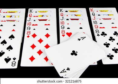 Playing cards being used for solitaire on black background