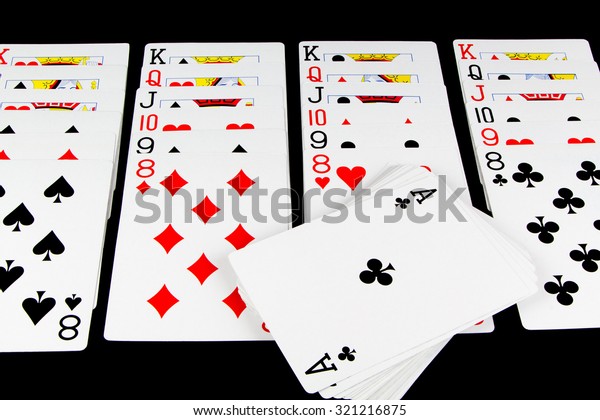 Playing cards being used for solitaire on\
black background