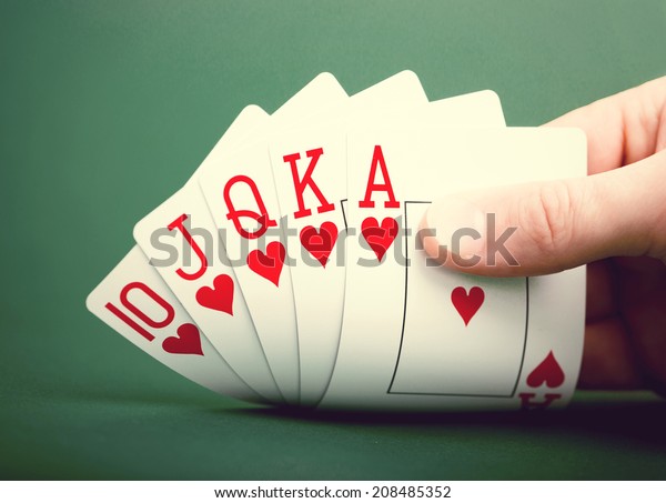 playing cards on a green\
table casino