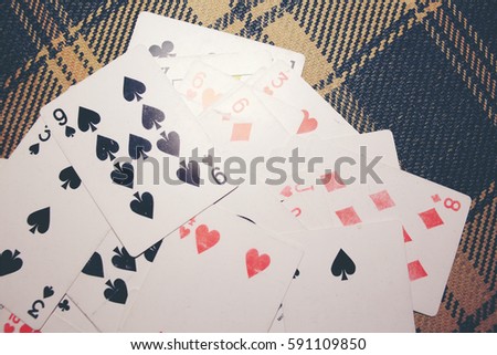 playing cards on  patterned fabrics background. Retro color style. Space for text.