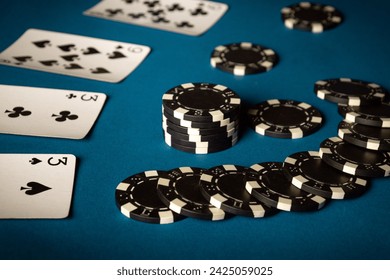 Playing cards and winning chips on a blue table in a poker club. Concept of winning a combination of cards from two pairs. - Powered by Shutterstock