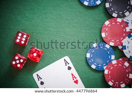 playing cards,dices and poker chips from above on green poker table