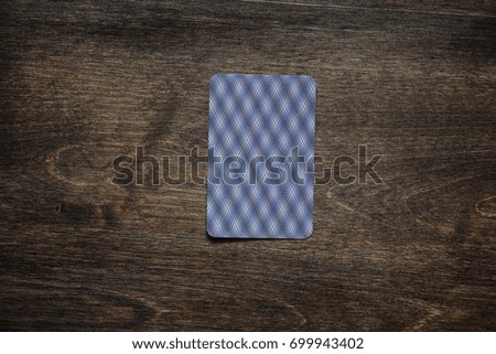 Playing chips on a wooden texture table and a deck of cards
