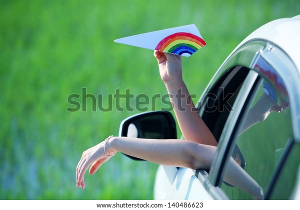 playing colorful\
paper airplane outside\
car.