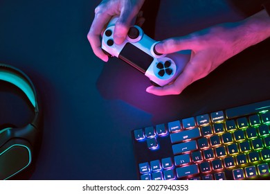 Playing computer game. Top down view of backlighted gaming accessories. Professional computer game playing, esport business and online world concept. - Powered by Shutterstock