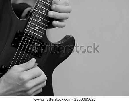 playing electric guitar with grey background with people stock photo
