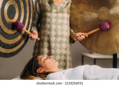 Playing gong in sound bath healing therapy  