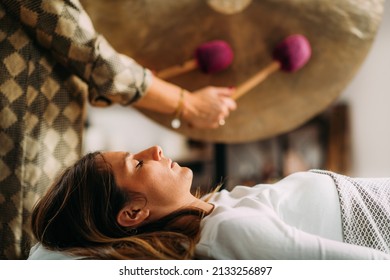 Playing Gong In Sound Bath Therapy  